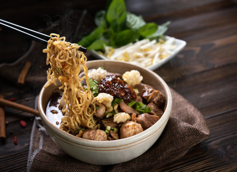 Image of a large bowl of Chinese soup with mushrooms and noodles