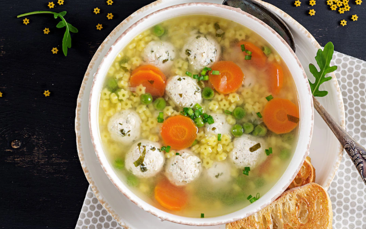 Image of a hearty Italian chicken meatball soup with carrots and pasta