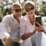 Image of older couple looking happily at a mobile phone