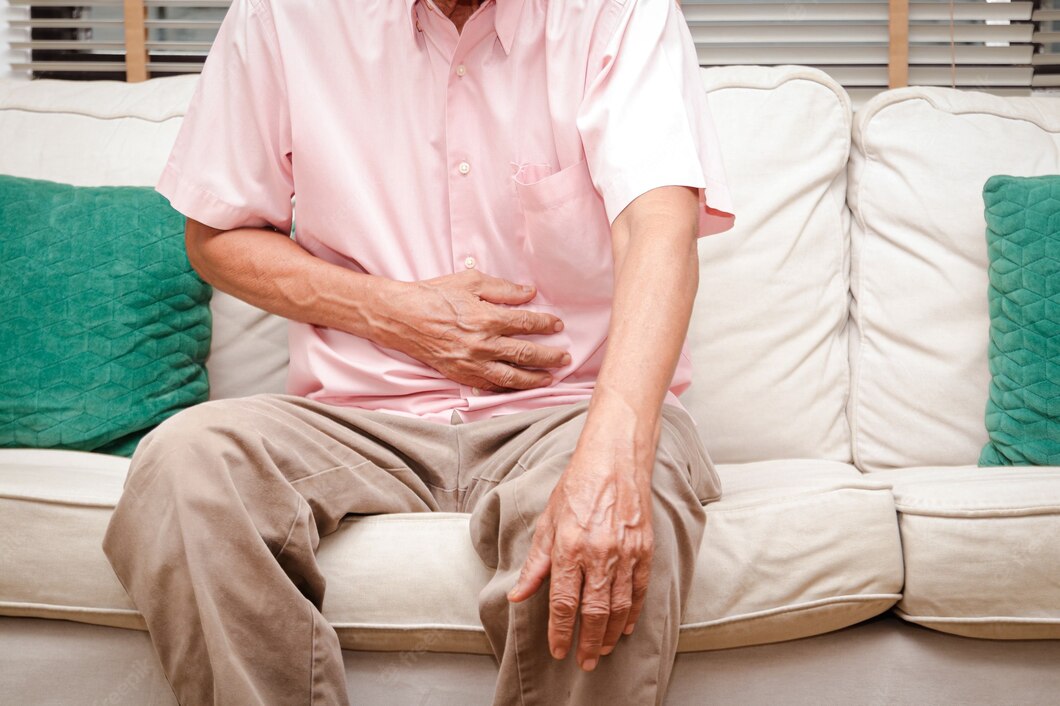 Image of older gentleman clutching at his stomach in pain