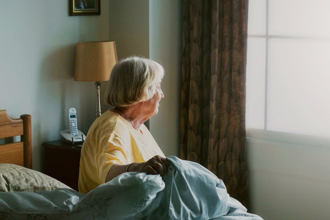 Image of a senior woman in self-isolation in her bedroom